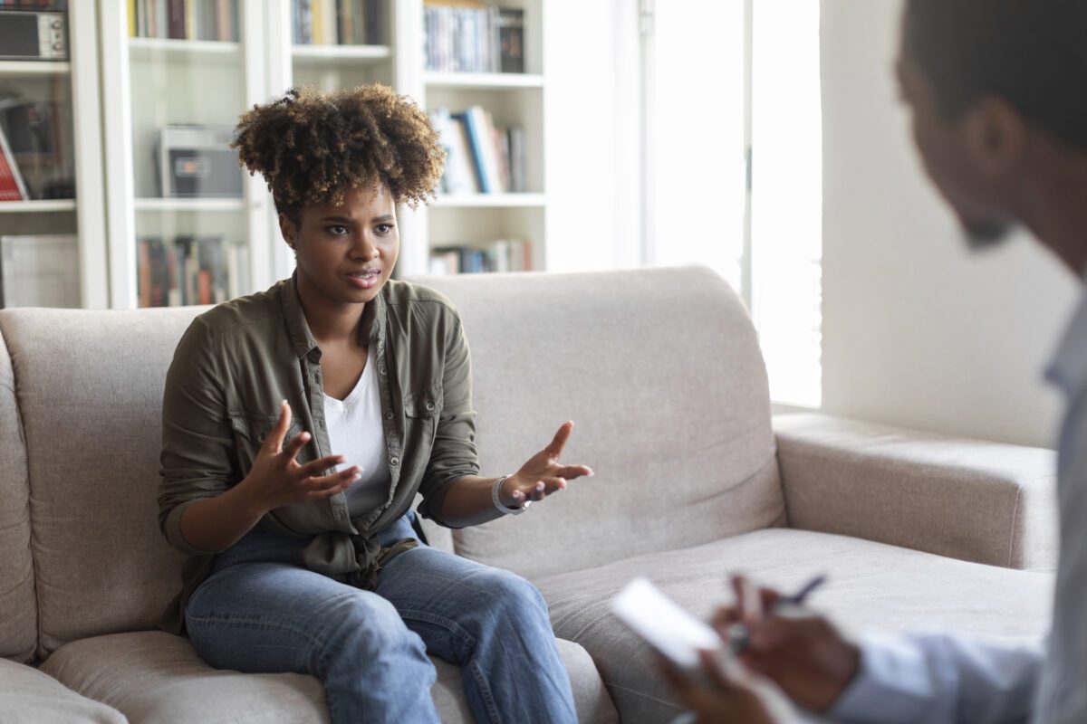 Emotional african american woman having therapy session with psychologist